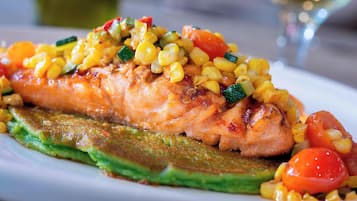 A plate of grilled salmon with vegetables.