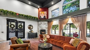 A modern lobby with a fireplace, seating area, and a view of the outdoors.