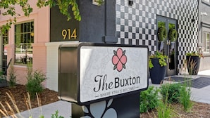 A mailbox with a floral design and the text 'The Buxton' indicating a hotel or establishment.