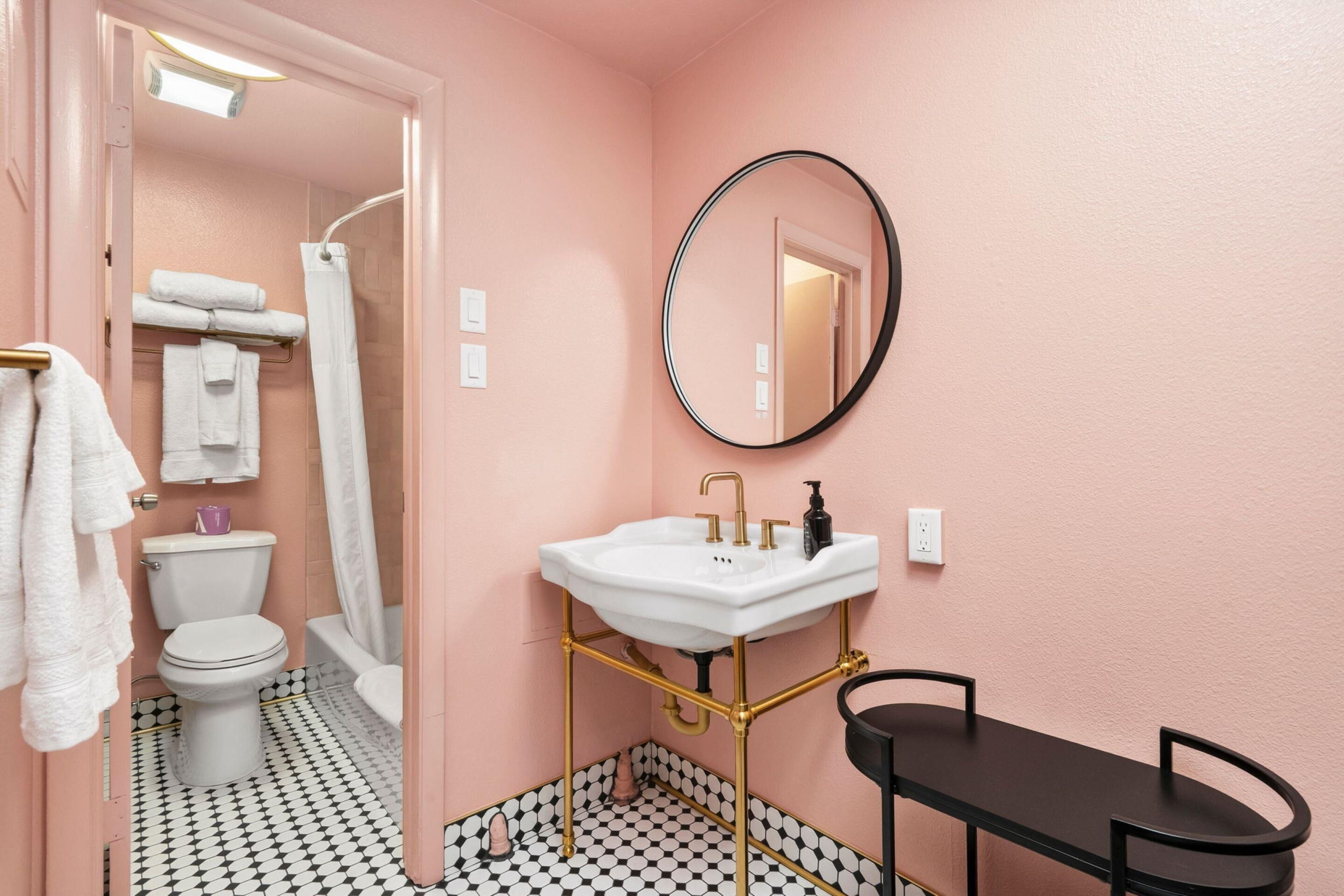 A bathroom with a toilet, sink, and shower.