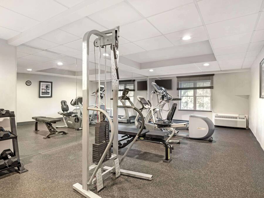 A modern gym with various exercise equipment, including treadmills and weight machines.