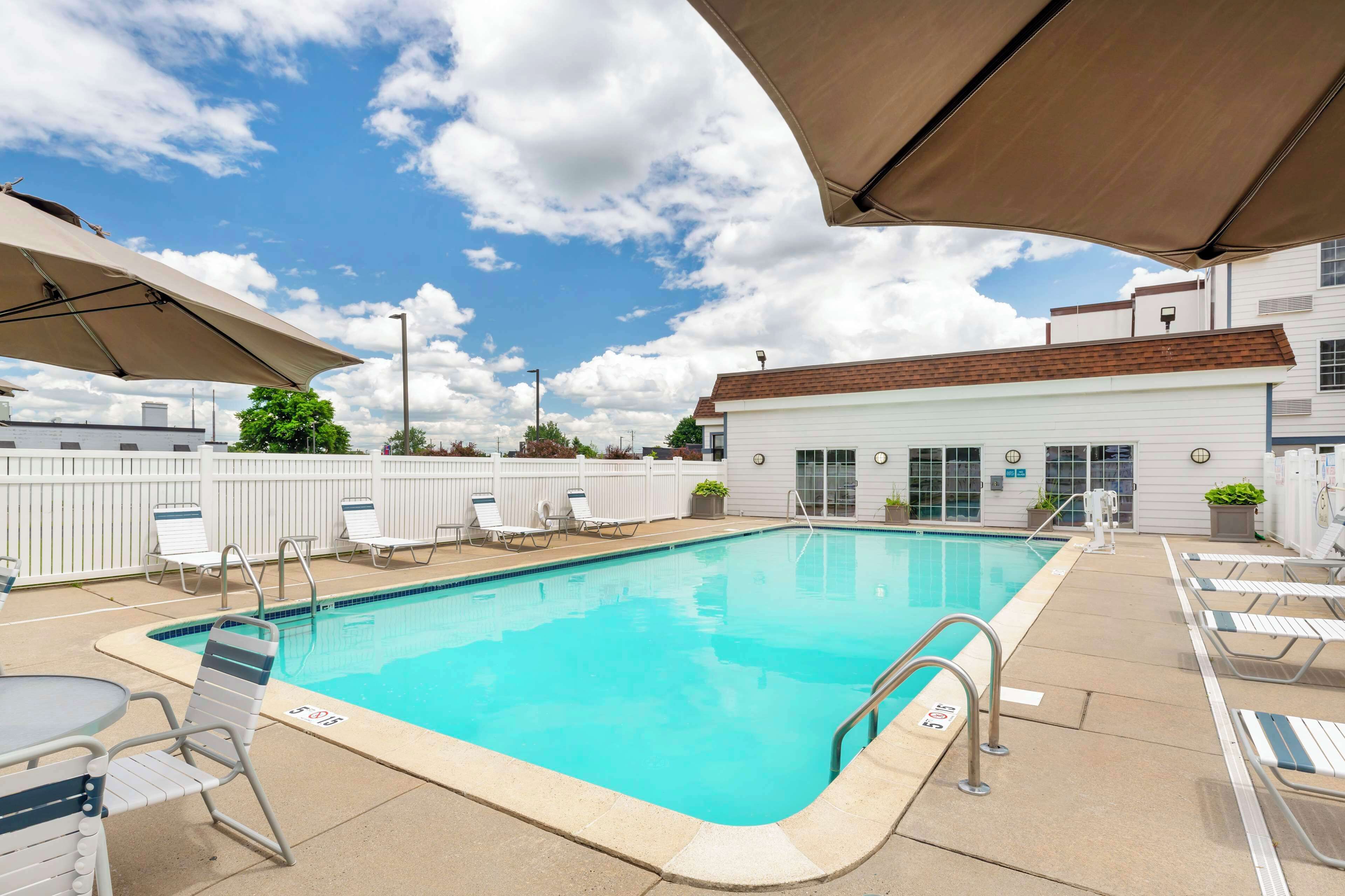 seasonal outdoor pool, open 8:00 am to 8:00 pm, pool umbrellas