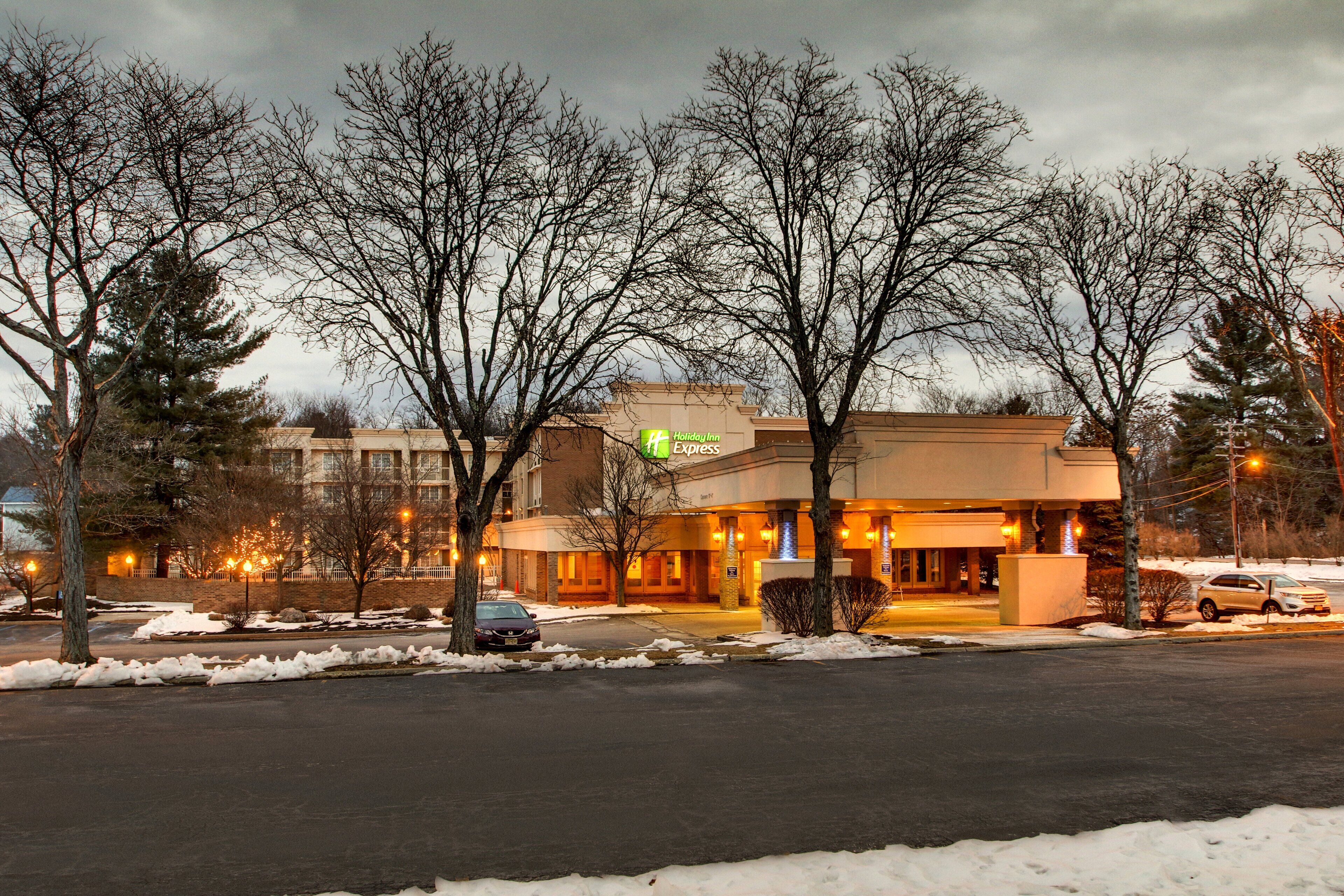 A Holiday Inn Express hotel with a parking lot and snow on the ground.