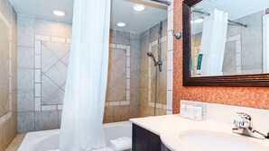 A modern bathroom with a bathtub, shower, and sink. - Hampton Inn by Hilton Chester South (Chester)