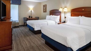 A hotel room with two beds, a desk, a chair, and a television. - Hampton Inn by Hilton Chester South (Chester)