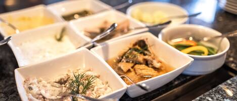 A buffet with various dishes including seafood, rice, and vegetables.