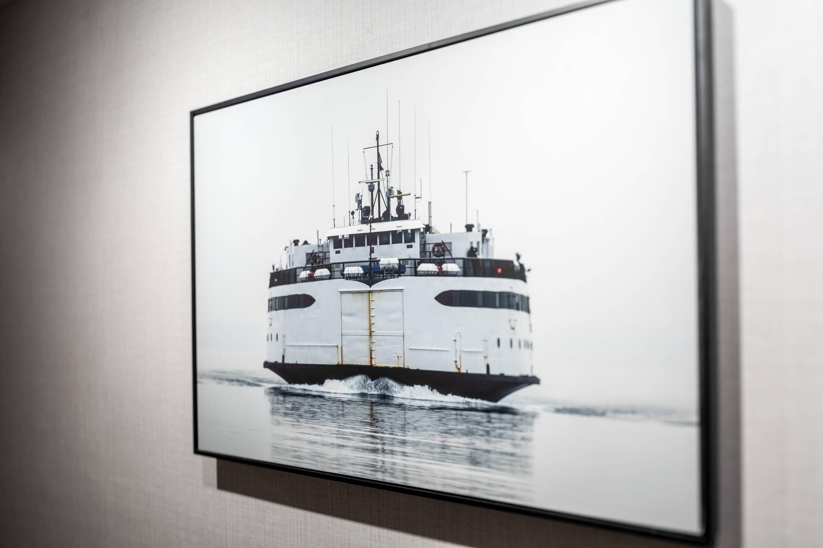 A framed picture of a ship on water.