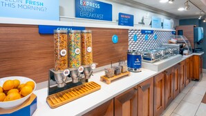 A breakfast bar with cereal dispensers, a bowl of oranges, and a sign reading "Express Start Breakfast". - Holiday Inn Express Miami Airport Doral Area by IHG (Miami)