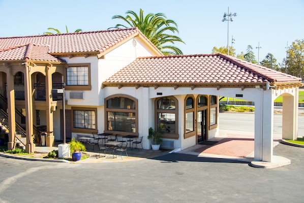 Stylish two-story building with a covered patio and outdoor seating area.