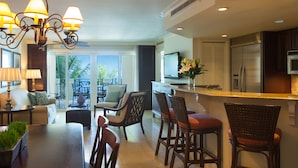 A spacious kitchen with a dining area, a large island, and a view of the outdoors.