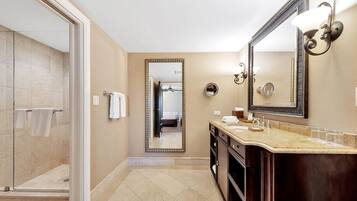 A modern bathroom with a shower, a large mirror, and a vanity with a sink.