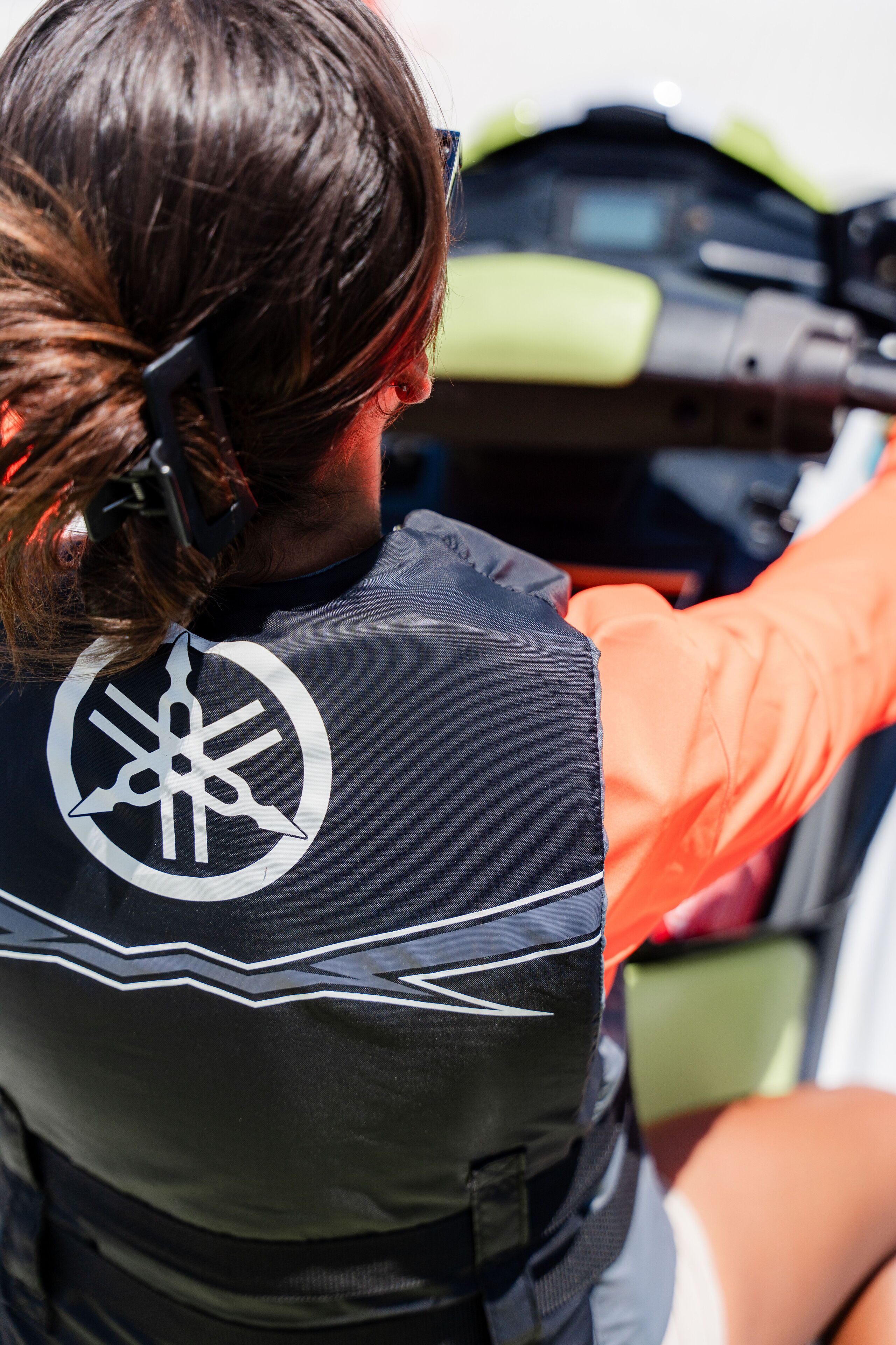 A person wearing a life jacket with a logo on the back.