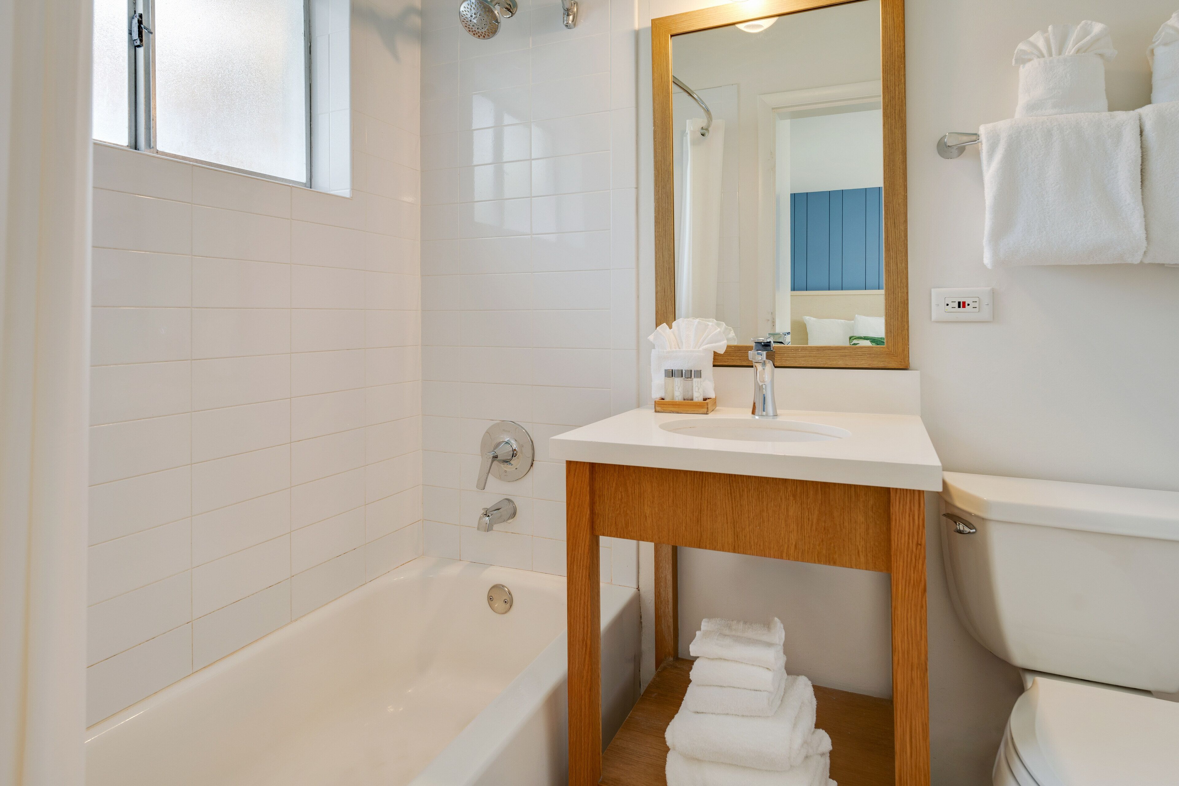 A modern bathroom with a bathtub, a sink, and a toilet.