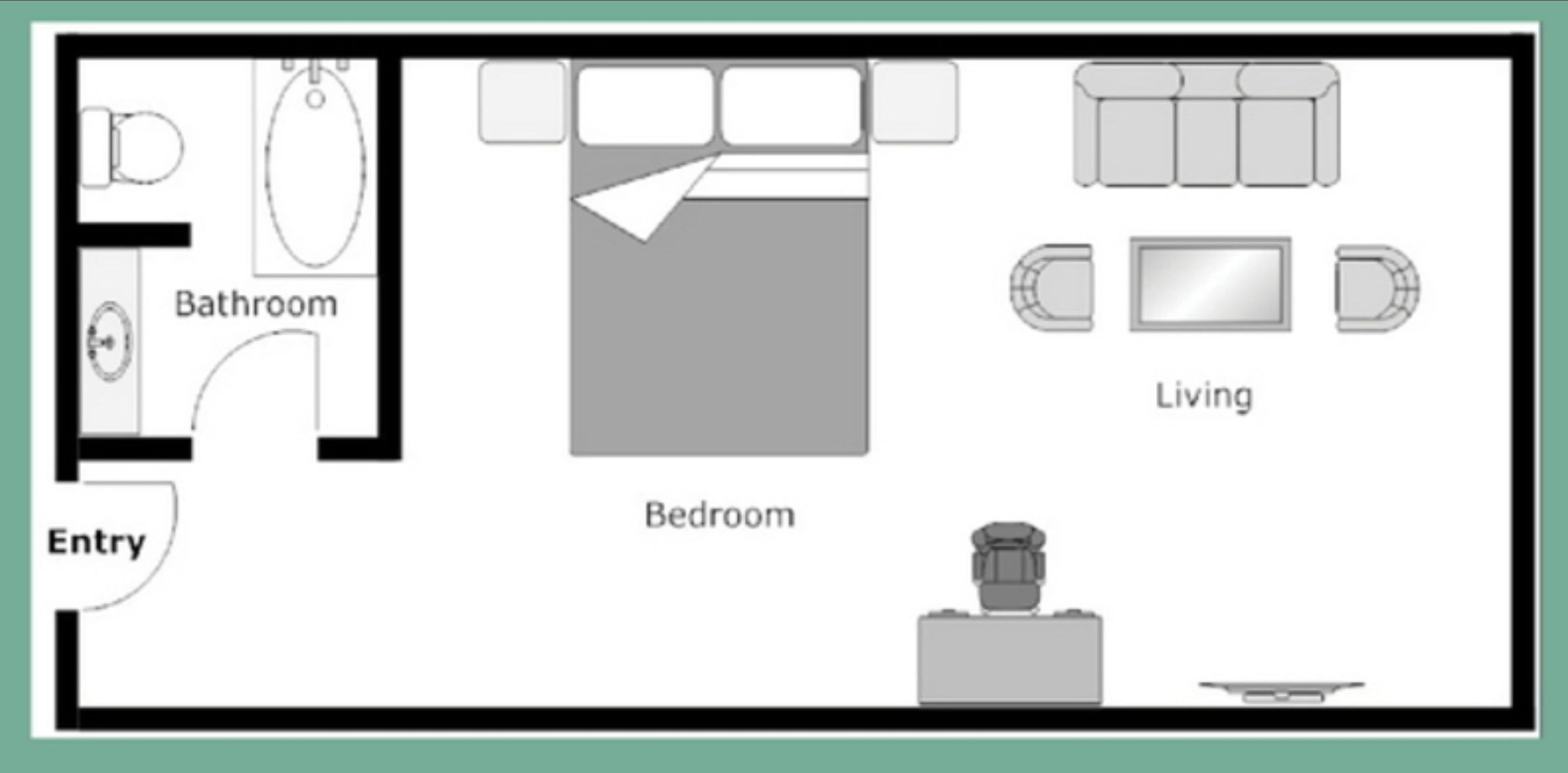 Un dormitorio con cama, baño y sala de estar con sofá y televisor.