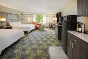 A hotel room with two beds, a desk, a chair, a microwave, a refrigerator, and a television. - Holiday Inn Charlottesville-Univ Area by IHG (Charlottesville)