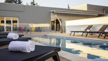 Seasonal outdoor pool, open 9:00 AM to 9:00 PM, pool loungers