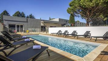 Seasonal outdoor pool, open 9:00 AM to 9:00 PM, pool loungers