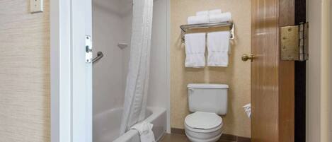 A bathroom with a bathtub, toilet, and towel rack.