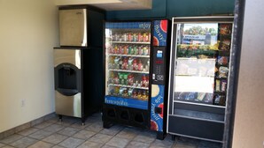 A vending machine with a beverage selection and a freezer unit. - Travel Inn Motel (Hartford)