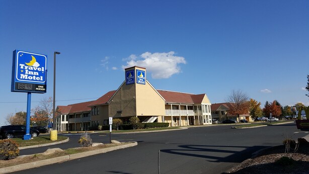A Travel Inn Motel with a prominent sign, a main building, and a parking lot. - Travel Inn Motel (Hartford)
