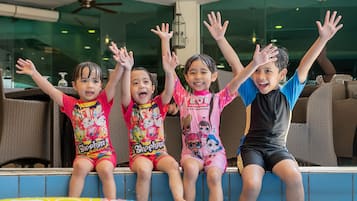 Children can splash and play in the pool surrounded by comfortable lounge chairs.