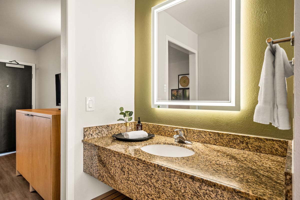 deluxe king suite sleeper sofa | bathroom | free toiletries, hair dryer, towels