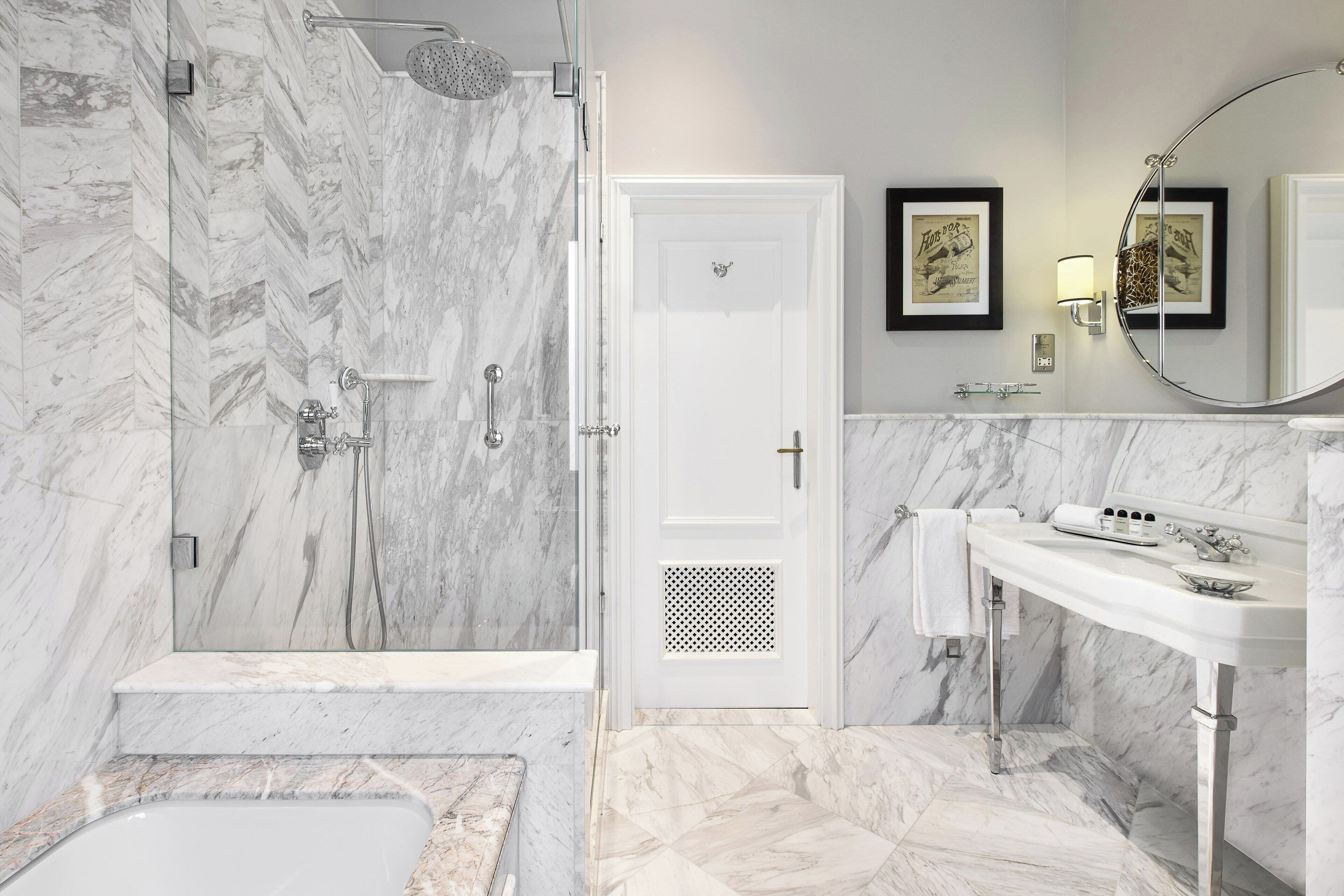 A modern bathroom with a shower, bathtub, and a sink.