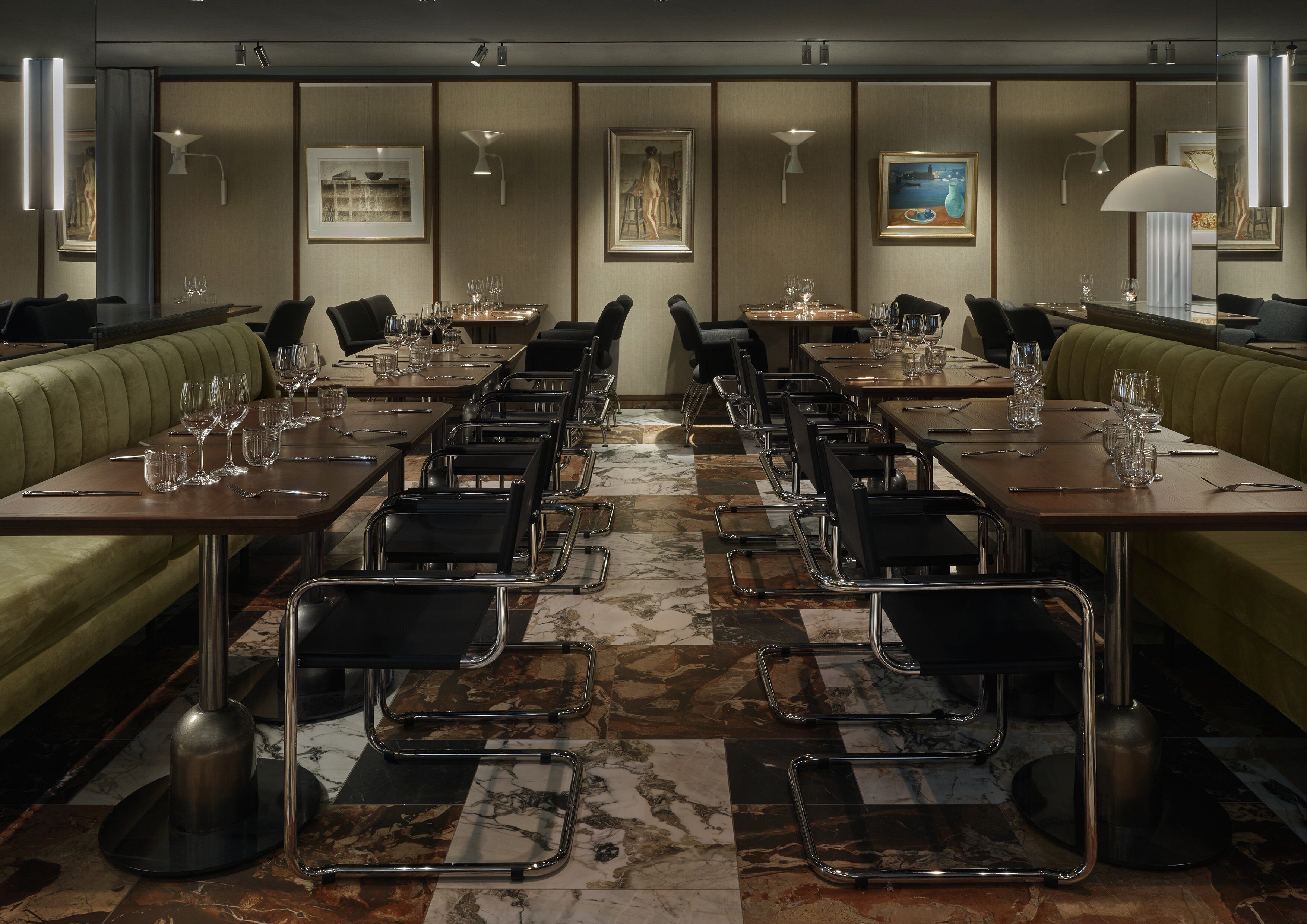 A hotel dining area with multiple tables and booths, equipped with chairs and dining essentials.