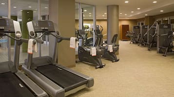 A gym with treadmills, elliptical machines, and weight equipment.