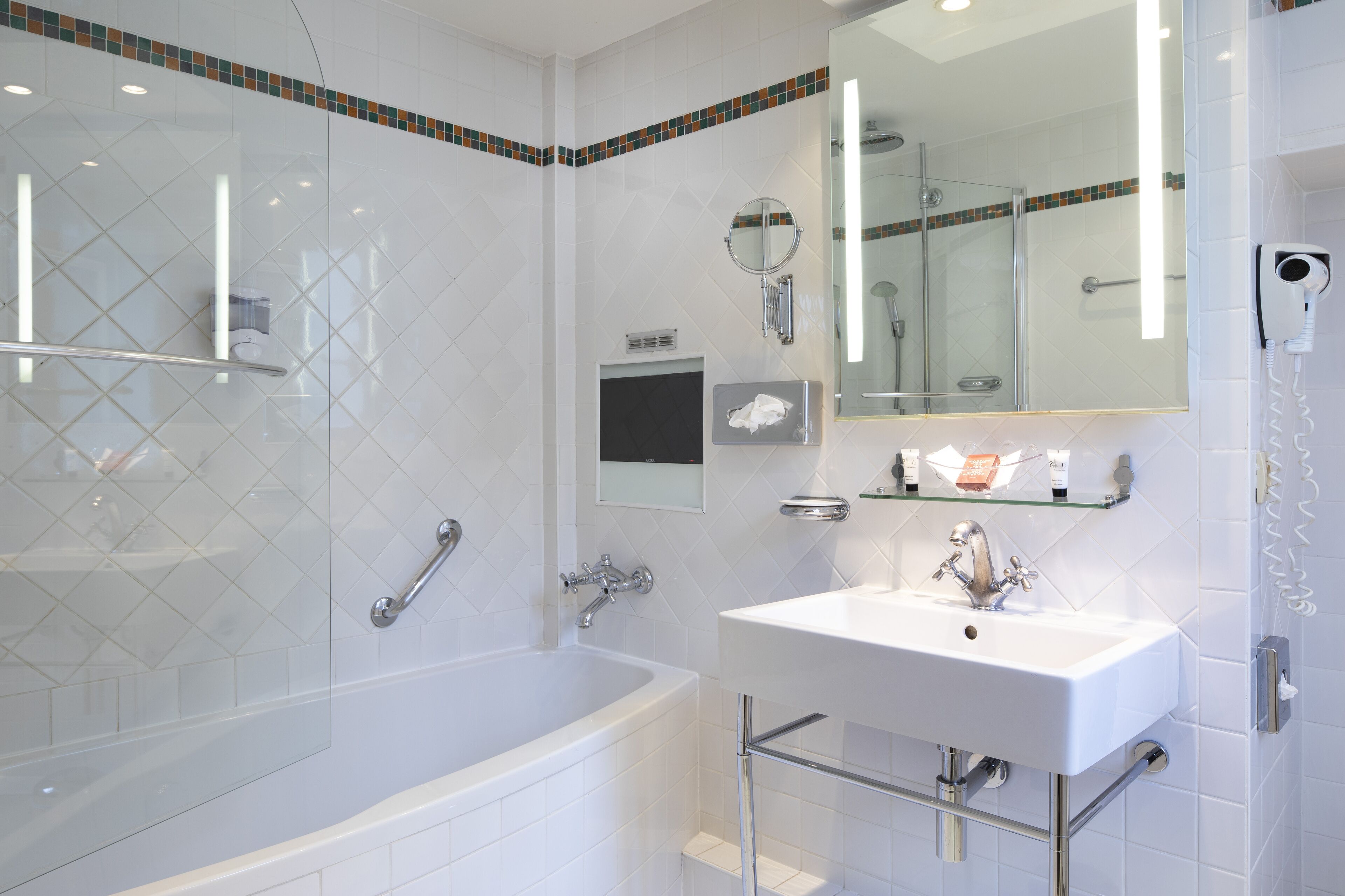 A modern bathroom with a glass-enclosed shower, a white sink, and a large mirror.