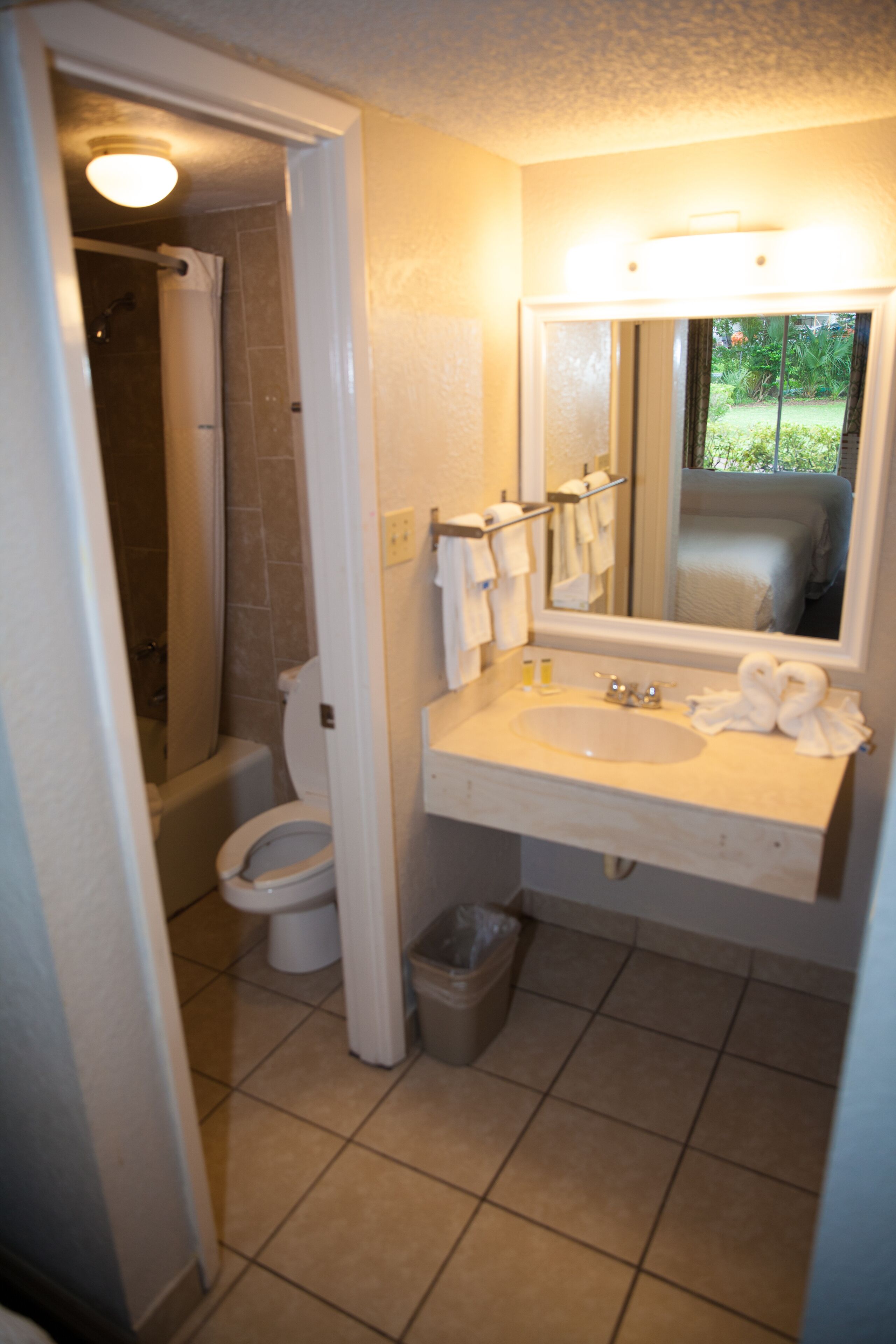 A bathroom with a toilet, sink, and shower.