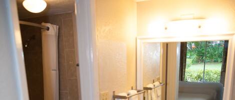 A bathroom with a toilet, sink, and shower.