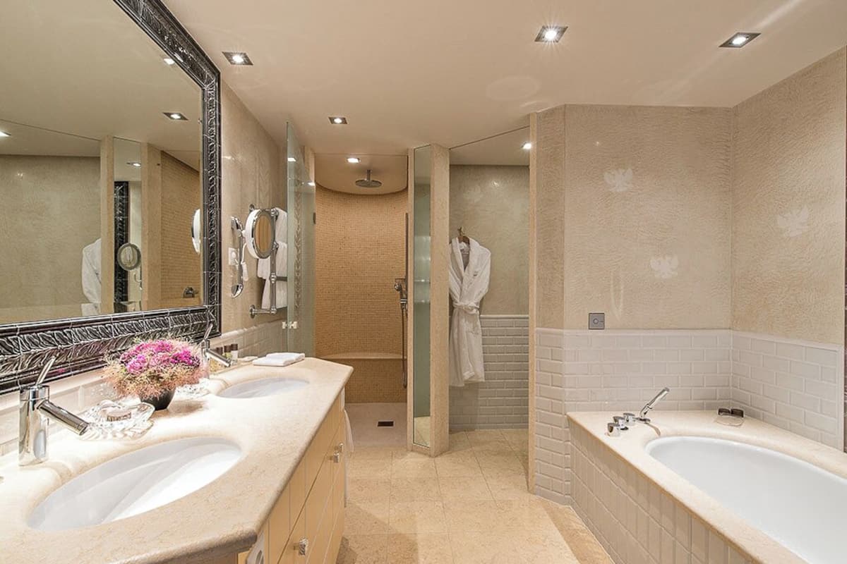 junior family suite, lake view (80 m²) | bathroom | separate bathtub and shower, rainfall showerhead, designer toiletries