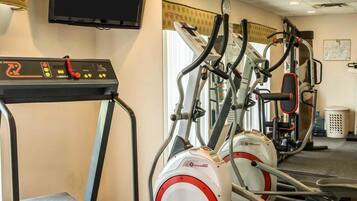 A gym with treadmills, ellipticals, and a stationary bike.