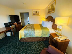 Relax in this inviting space with a comfortable bed, desk, and television.