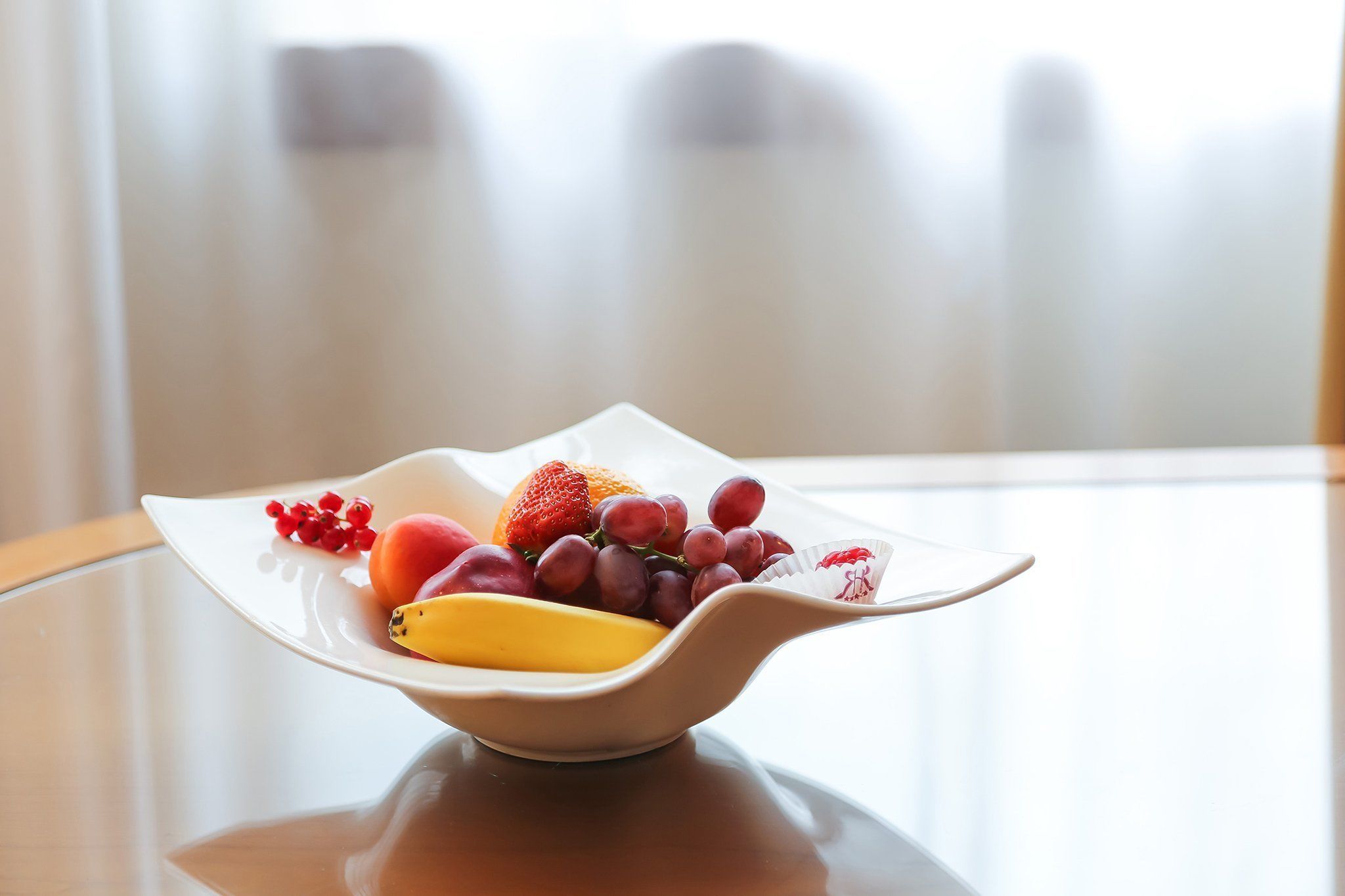 A fruit bowl on a table with a blurred background.