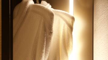 A white towel with a logo hanging on a door.