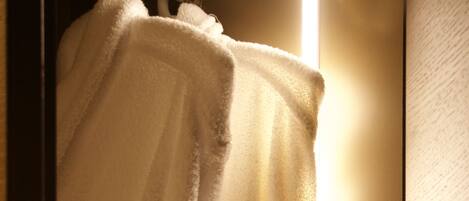 A white towel with a logo hanging on a door.