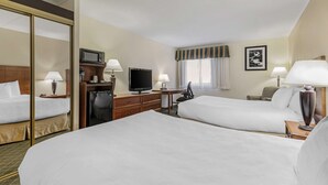 A hotel room with two beds, a desk with a television, a minibar, and a window with curtains. - Best Western Plus Augusta Civic Center Inn (Augusta)