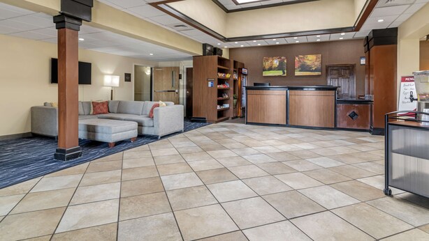 A hotel lobby with a reception desk, seating area, and a coffee station. - Best Western Plus Augusta Civic Center Inn (Augusta)
