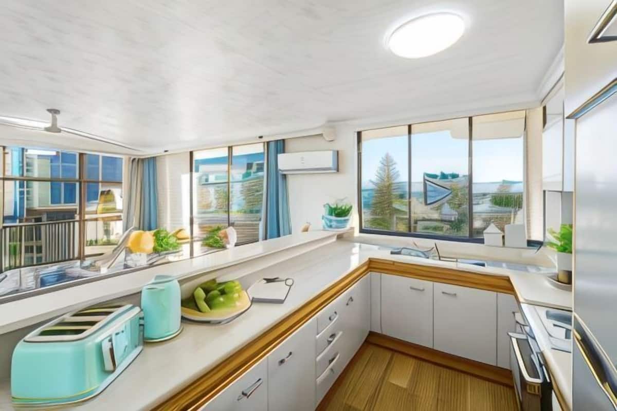 A modern kitchen with a large window, a built-in oven, and a sink.