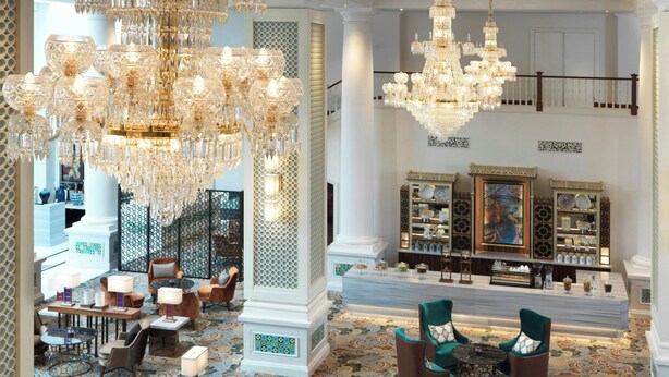 A lobby with chandeliers, seating, a reception desk, and a patterned floor. - Frasers House, a Luxury Collection Hotel, Singapore (Singapore)