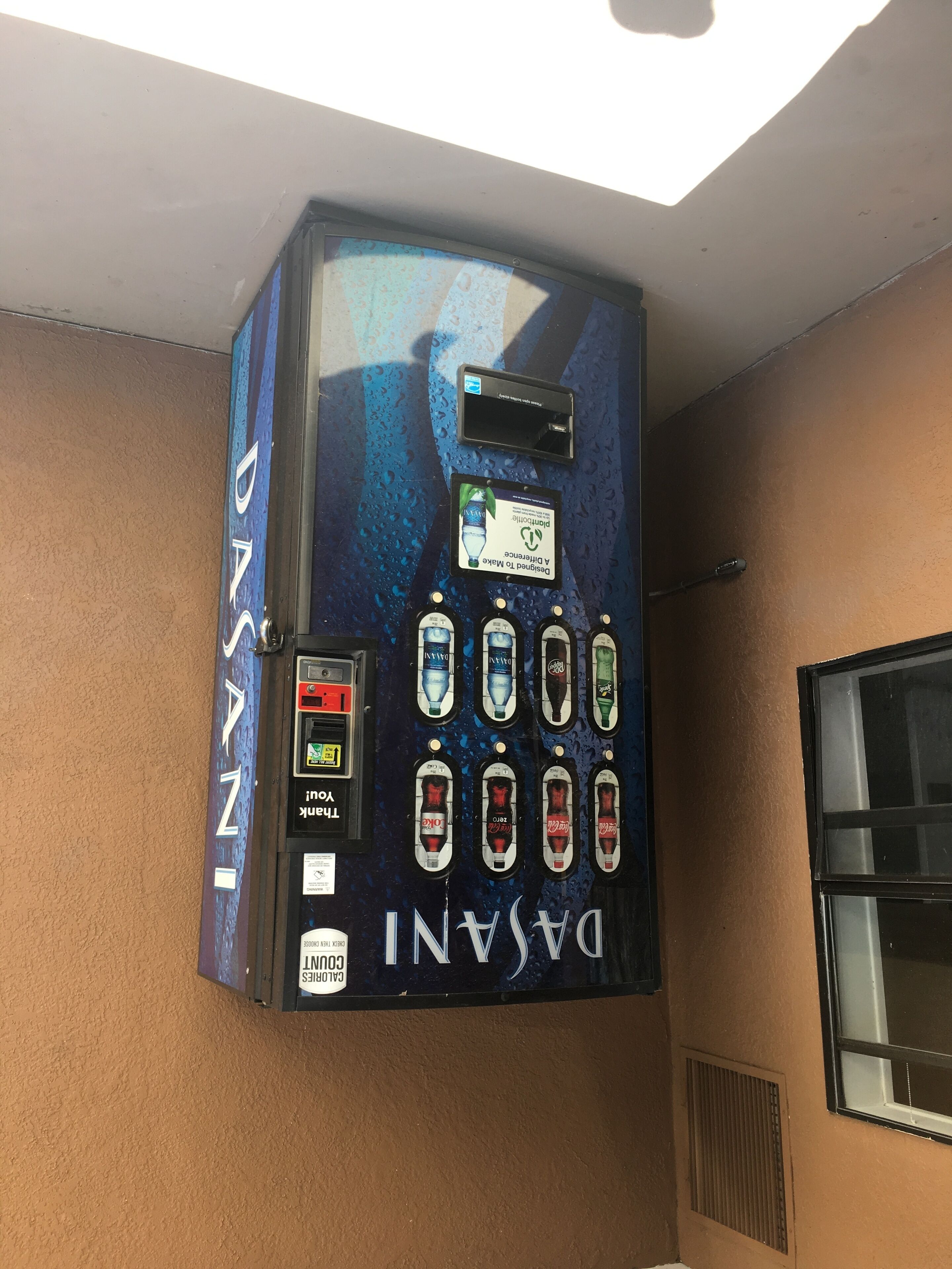 A Dasani water vending machine with multiple beverage options.