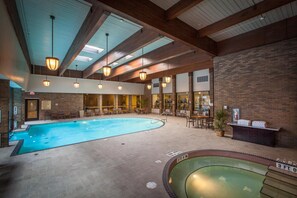 An indoor swimming pool with a sunroof, lounge area, and reception desk. - DoubleTree by Hilton Pittsburgh - Green Tree (Pittsburgh)