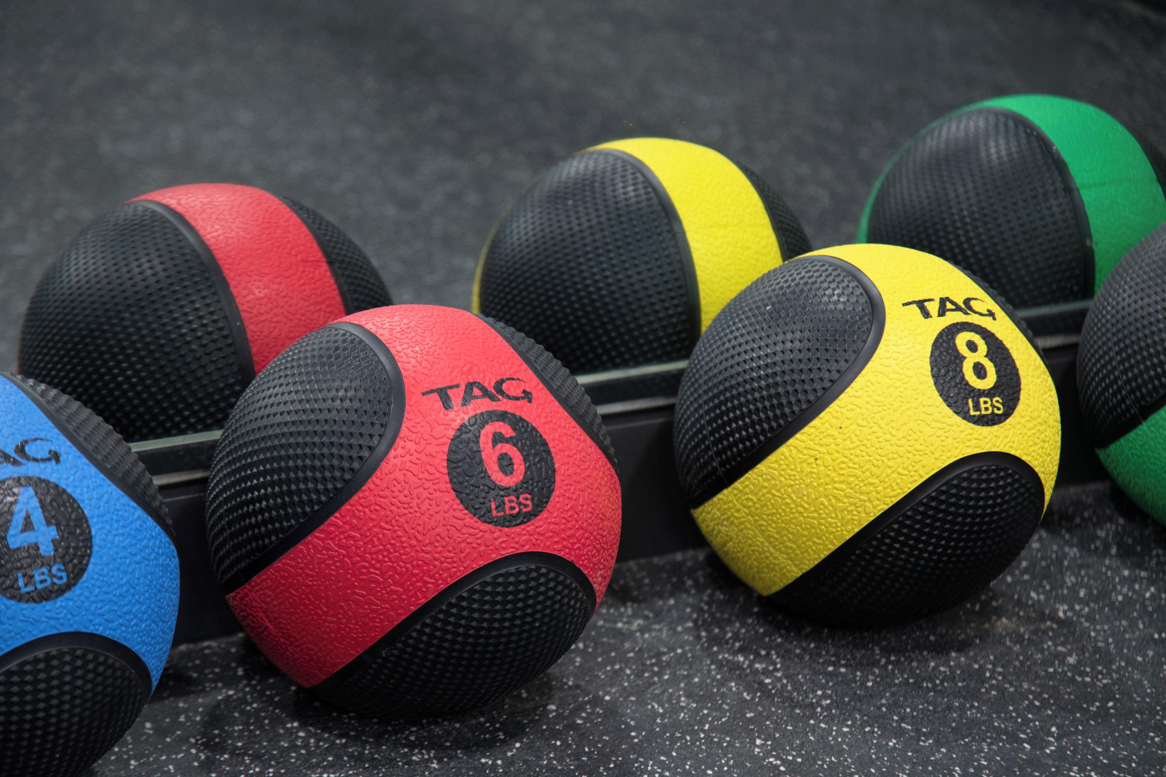 A collection of exercise balls with varying weights and colors.