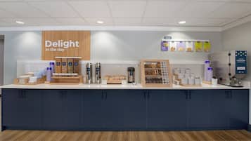 A counter with various food and drink options, including a sign that reads 'Delight in the day'.