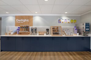 A counter with various food and drink options, including a sign that reads 'Delight in the day'.