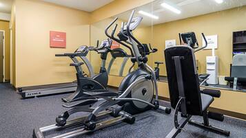 A gym with various exercise equipment, including treadmills and a stationary bike.
