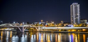 A nighttime cityscape with a prominent bridge and a tall building labeled "Park Regis." - Park Regis Hotel Brisbane (Brisbane)