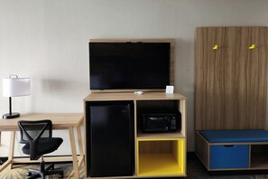 A compact room with a desk, a chair, a television, a microwave, and a wardrobe. - Days Inn by Wyndham Monroe LA (Monroe)